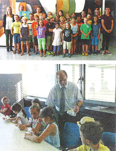 Ausschnitt aus dem Presseartikel: Bürgermeister Stadel mit Kindern vor einem Laptop